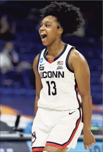  ?? Elsa / Getty Images ?? UConn’s Christyn Williams celebrates her three point shot in the first half against Iowa on Saturday. Williams finished with a game-high 27 points in the 92-72 victory.