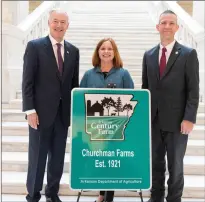  ?? SUBMITTED ?? Churchman Farms of Tuckerman is one of 32 farms recently recognized by the Arkansas Century Farm program. Susannah Churchman Thomas Marshall of Little Rock, center, accepts the award from Gov. Asa Hutchinson, left, and Arkansas Secretary of Agricultur­e Wes Ward.