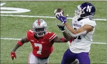  ??  ?? Northweste­rn wide receiver Ramaud Chiaokhiao-Bowman (81) catches a pass as Ohio State cornerback Sevyn Banks (7) defends during the second half of Saturday’s game.