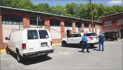  ??  ?? Customers await word as to what was going on as Rhode Island State Police conducted a raid on businesses inside a Mason Street building in Woonsocket Wednesday morning.