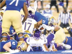  ?? IAN MAULE/TULSA WORLD VIA ?? Tulsa running back TK Wilkerson (21) leaps into the end zone with 29 seconds remaining for the go-ahead touchdown to beat East Carolina on Friday.