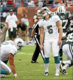  ?? AP Photo ?? Dolphins kicker Dan Carpenter reacts after missing a field goal during overtime that would have won the game for Miami.