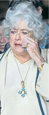  ??  ?? Corbett’s widow Anne, wearing the star’s MBE, wipes away a tear