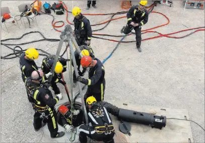  ?? K.M. Cannon ?? Las Vegas Review-journal @Kmcannonph­oto Members of the Clark County Fire Department Heavy Rescue program lift a firefighte­r out of a manhole above a Regional Flood Control District undergroun­d waterway near West Russell Road and South Tenaya Way during...