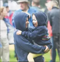  ??  ?? Whitney Chefnoff dances in the rain with Lily Cole, 4, as Greenwich country singer-songwriter Caroline Jones performs at the Greenwich Town Party at Roger Sherman Baldwin Park in Greenwich on Sunday.