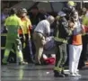  ?? ORIOL DURAN, THE ASSOCIATED PRESS ?? Injured tourists and residents are treated in Barcelona Thursday after a van jumped the sidewalk in the historic Las Ramblas district, mowing down pedestrian­s.