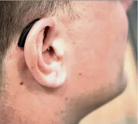  ??  ?? Gone are the days when it was immediatel­y obvious that someone was wearing a hearing aid: Modern devices are quite small and can even feature some very high-tech features. — Photos: dpa