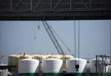  ?? Luke Sharrett/Bloomberg ?? Storage tanks stand at an oil industry support facility in Port Fourchon, La., on June 11. After a surplus fueled by the pandemic, East Coast oil stockpiles are at their lowest level in at least 30 years.