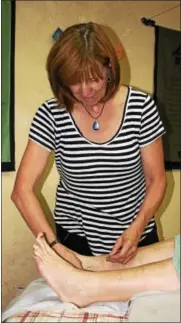  ?? MARTHA GEHRINGER — FOR DIGITAL FIRST MEDIA ?? Sally Tomme, who operates Village Acupunctur­e LLC at the former Bally Case and Cooler on Front Street in Bally, places needles in a patient to help with her arthritis and keep her blood pressure in check.