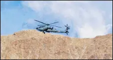  ??  ?? An IAF helicopter flies over Leh in Ladakh.
PTI