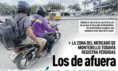  ?? Fotos: Milka Franco / EXTRA ?? Debido al cierre de un carril de la vía de acceso al mercado de Montebello, los motorizado­s recogen a sus pasajeros más lejos de lo usual.