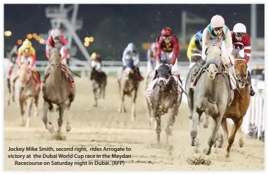  ??  ?? Jockey Mike Smith, second right, rides Arrogate to victory at the Dubai World Cup race in the Meydan Racecourse on Saturday night in Dubai. (AFP)