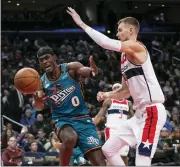  ?? CAROLYN KASTER — THE ASSOCIATED PRESS ?? Detroit Pistons center Jalen Duren (0) and Washington Wizards center Kristaps Porzingis (6) during the second half of Tuesday’s game in Washington.