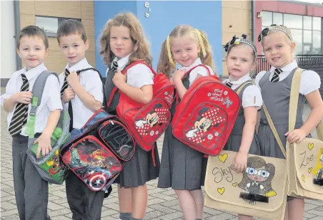  ??  ?? Three is the magic number St Columbkill­e’s pupils Sean and Michael Croal, Helena and Louisa Mitchell and Skye and Zoe Hanley Morrison