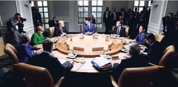  ?? AP ?? Clockwise from background centre, Prime Minister Justin Trudeau sits with President of France Emmanuel Macron, Japanese Prime Minister Shinzo Abe, Italian Prime Minister Giuseppe Conte, President of the European Commission Jean-Claude Juncker,...