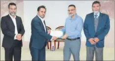  ?? ?? Abdul Khaliq presents a certificat­e to Head of Informatio­n Security Assurance Dr Muhammad Ali Malik as Founder of Cytellect Ahmad Javaid and PEF President Riyaz Bakali look on.