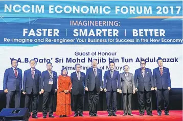  ??  ?? Najib (sixth left) take a group photo during the launch of the NCCIM Economic Forum 2017 yesterday. Also present are Internatio­nal Trade and Industry Minister, Datuk Seri Mustapa Mohamed (fifth left) and Ter (fourth right). — Bernama photo