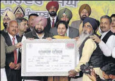  ?? HT FILE ?? Punjab CM Capt Amarinder Singh handing over a debt relief certificat­e to a farmer on December 7.