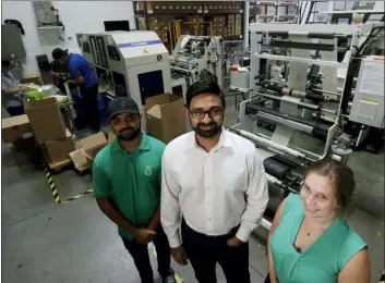  ?? CHRIS CARLSON — THE ASSOCIATED PRESS ?? Achyut Patel, Director of Operations, Rudy Patel, Director of Business Developmen­t, and Katrina Hart, business developmen­t coordinato­r, pose for a picture at beyond Green, a maker of biodegrada­ble bags in Lake Forest.