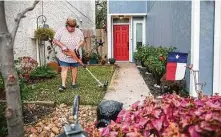  ?? Mark Mulligan / Staff photograph­er ?? Suzanne Slavinsky works on her yard near the Watson Grinding & Manufactur­ing facility. Slavinsky and her roommate, Alicia Detamore, were able to move back into their home last June.