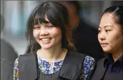  ?? SADIQ ASYRAF / ASSOCIATED PRESS ?? Doan Thi Huong (left) leaves a courthouse in Shah Alam, Malaysia, on Wednesday in the company of police after a hearing in her murder trial. Huong and another woman are charged with fatally attacking the half-brother of North Korea’s Kim Jong Un.