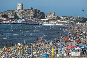  ?? — AFP ?? people relaxing on a beach on the black sea coast in the sile district of Istanbul province.