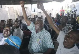  ?? PIUS
UTOMI EKPEI/
GETTY IMAGES ?? People react as early results of the Nigerian presidenti­al elections are released on Tuesday. Opposition candidate Muhammadu Buhari pulled ahead of incumbent Goodluck Jonathan and went on to win.