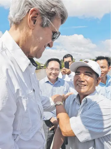  ?? Picture: AP ?? WARTIME ADVERSARIE­S: John Kerry with former Viet Cong guerrilla Vo Ban Tam, 70, who took part in the attack on the US Secretary of State’s naval gunboat on February 28, 1969.