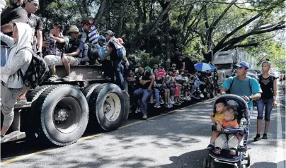  ?? PHOTO: REUTERS ?? Heading north . . . Central American migrants, part of a second wave of migrants on the way to the United States, hitchhike on a truck in Chiquimula, Guatemala, yesterday as they continue their journey to the Mexican border.