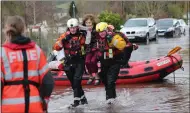  ??  ?? A woman is lifted to safety in Whitchurch, Herefordsh­ire