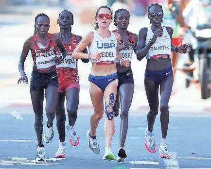  ?? GETTY IMAGES ?? American Molly Seidel runs in the Tokyo Olympics women’s marathon alongside Kenya’s Peres Jepchirchi­r, Bahrain’s Eunice Chebichii Chumba, Kenya’s Brigid Kosgei and Israel’s Lonah Chemtai Salpeter.