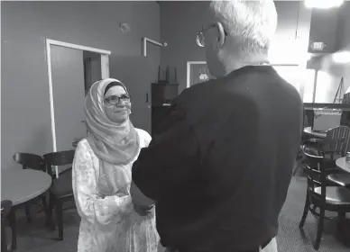  ?? Associated Press ?? n Moina Shaiq speaks to a man after a Meet a Muslim event at Bronco Billy’s Pizza Palace in Fremont, Calif. Shaiq discussed the importance of the hijab, the head scarf, and the niqab, the face covering, as well as the difference­s between Sunnis and...