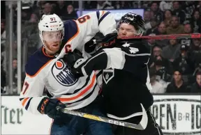  ?? The Associated Press ?? Edmonton Oilers centre Connor McDavid, left, and Los Angeles Kings defenceman Mikey Anderson battle during the first period in Game 6 of their NHL Stanley Cup first-round playoff series on Thursday in Los Angeles.