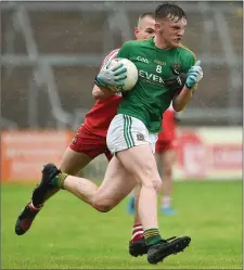  ??  ?? Adam Reilly of Meath is tracked by PJ McAleese of Derry.