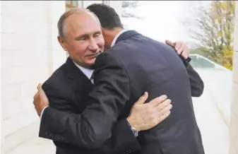  ?? Mikhail Klimentyev / Associated Press ?? Russian President Vladimir Putin (left) hugs Syrian President Bashar Assad in the Black Sea resort of Sochi. Assad has ventured outside his nation twice since the conflict began in 2011.