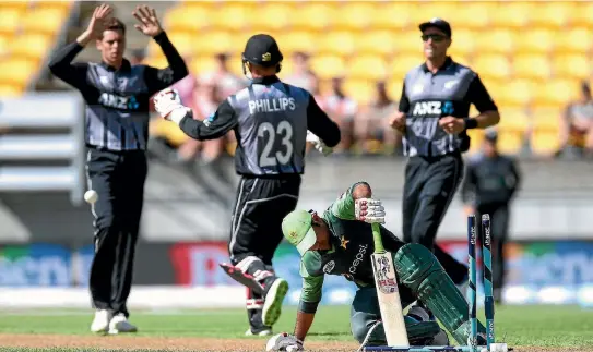  ?? PHOTOS: GETTY IMAGES ?? Mitchell Santner of New Zealand celebrates with Glenn Phillips after taking the wicket of Sarfraz Ahmed of Pakistan in a T20 internatio­nal earlier this season.