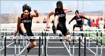  ?? JOHN T. DENNE/For the Taos News ?? A sunny spell allowed a trio of Taos hurdlers to compete without wearing an extra layer during the Taos Tigers Invite at Anaya Stadium April 6. Inclement weather persisted throughout the meet, which was subsequent­ly called off early when the weather did not improve.