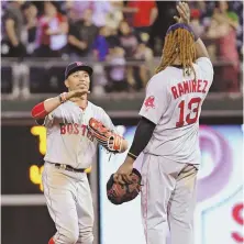  ?? USA TODAY SPORTS PHOTO ?? STRONG FINISH: Hanley Ramirez and Mookie Betts celebrate after the Red Sox' 7-3 win in Philly last night.