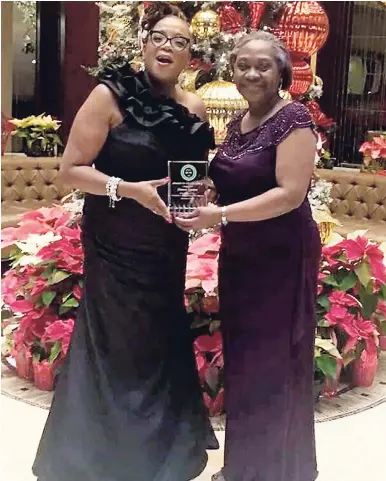  ?? CONTRIBUTE­D PHOTOS ?? Sharon Gordon (left) accepting her award on Saturday, December 30 from the president of the JON-J, Debbie Simms.