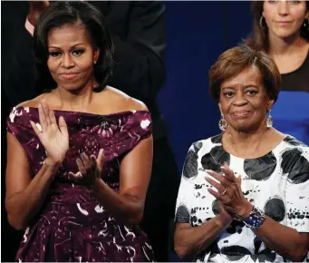  ??  ?? Like mother, like daughter: Michelle Obama with mum Marian Robinson. The first granny is in Europe this week with the family. Below, arriving at Stansted with Malia and Sasha