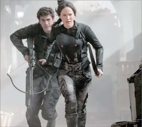  ?? PICTURE: NU METRO PICTURES ?? MOVING TARGETS: Katniss Everdeen (Lawrence) and Gale Hawthorne (Hemsworth) in one of the rare action scenes in The Hunger Games: Mockingjay – Part 1.