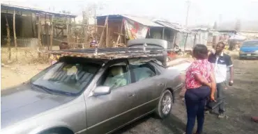  ??  ?? Omale picks the remains from her wife shop in the market