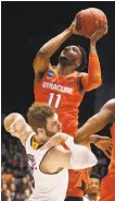  ?? John Minchillo / Associated Press ?? Syracuse’s Oshae Brissett soars over Arizona State’s Mickey Mitchell to score.