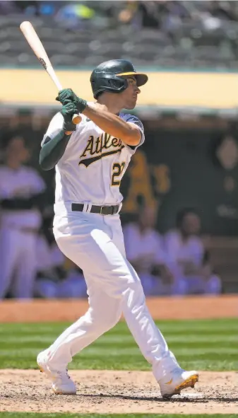  ?? Tony Avelar / Associated Press ?? Matt Olson follows the baseball on a fifthinnin­g double. He added a sacrifice fly in the seventh.