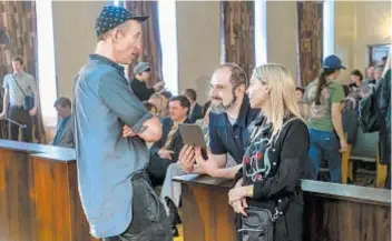  ??  ?? SERIES DIRECTOR Johan Renck, left, writer-executive producer Craig Mazin and executive producer Jane Feathersto­ne confer on the “Chernobyl” set.