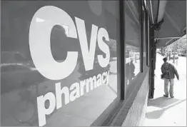  ?? MATT ROURKE/AP 2014 ?? CVS reported earnings that were better than expected for the third quarter and it also announced it’s starting same-day delivery of prescripti­ons in some markets.