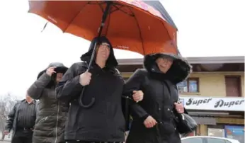  ?? LARS HAGBERG/THE CANADIAN PRESS ?? Former teacher Jaclyn McLaren, holding umbrella, pleaded guilty to two counts of sexual exploitati­on.