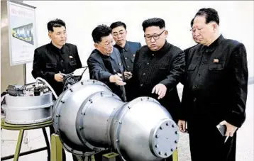  ?? KOREAN CENTRAL NEWS AGENCY ?? In a photo issued Sunday by North Korea, Kim Jong Un, second from right, examines a device at an undisclose­d location.