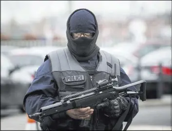  ?? KAMIL ZIHNIOGLU/THE ASSOCIATED PRESS ?? A police officer patrols Saturday at Orly airport, south of Paris. A man was shot to death after trying to seize the weapon of a soldier guarding the airport.