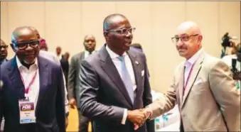  ?? ?? Governor Babajide Sanwo-Olu in a handshake with Mark Pace; Bashir Are (left)